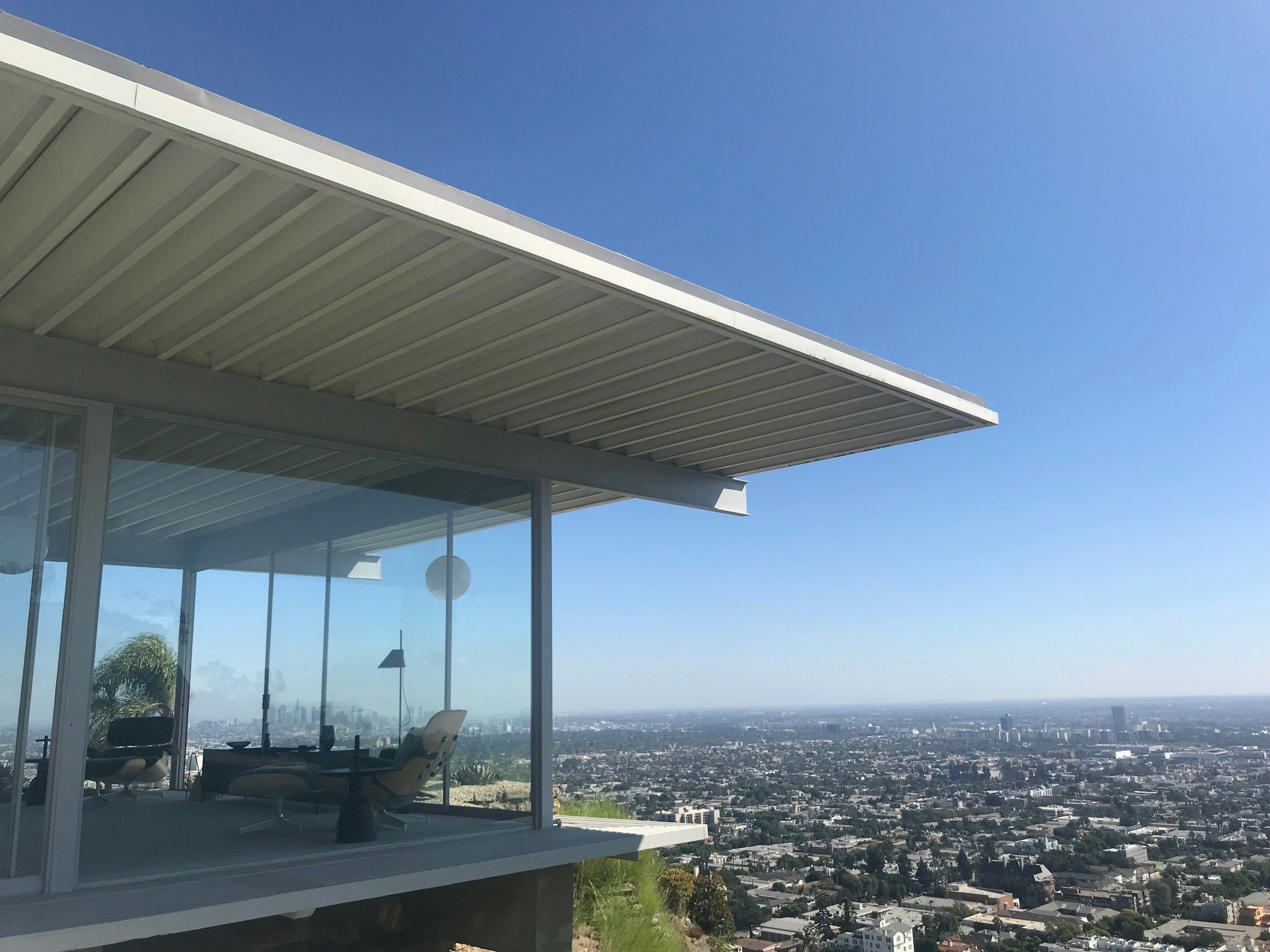A glass house above the city, its roof reaching out over the view