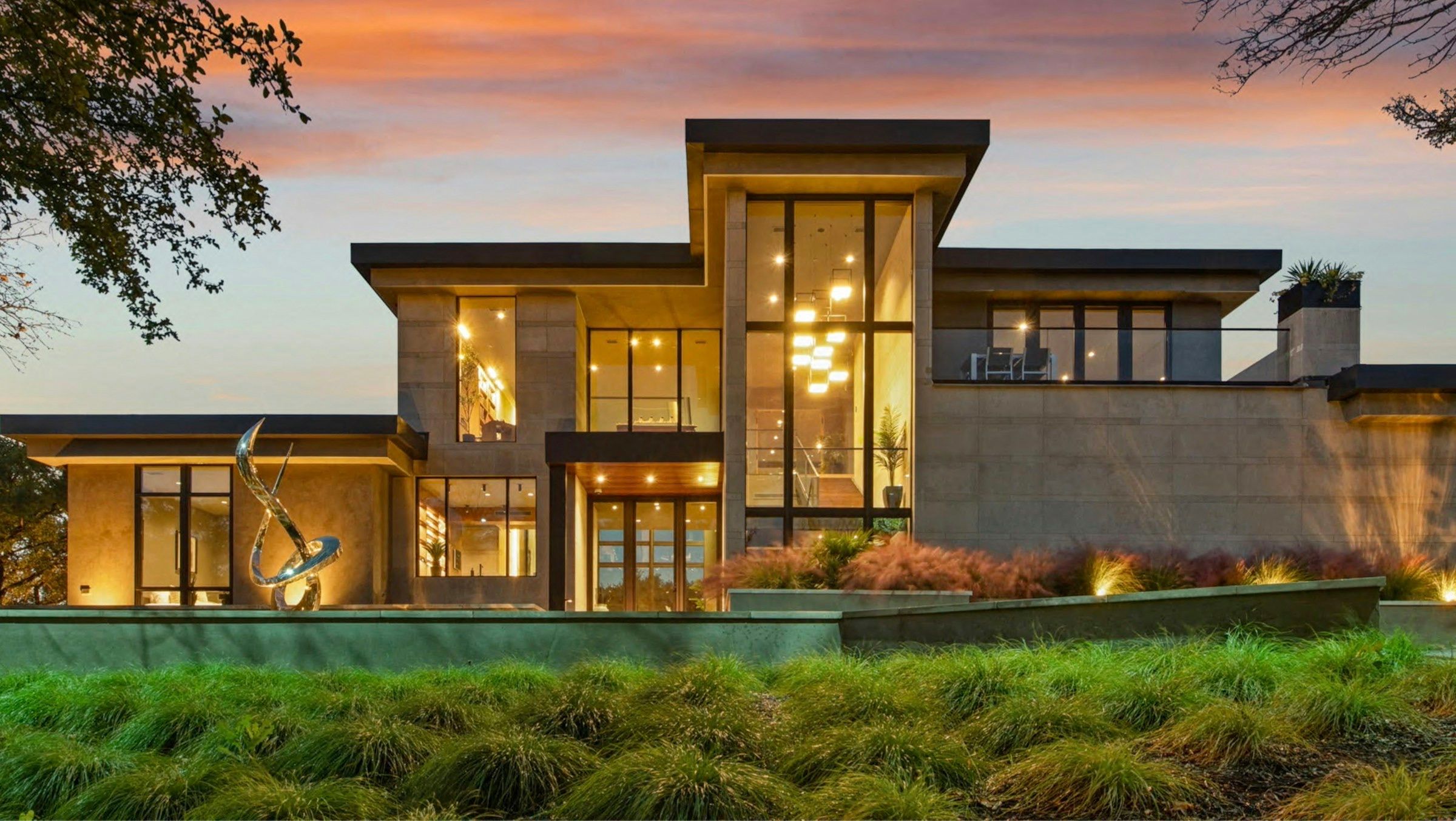 A new modern house of stone and glass at dusk
