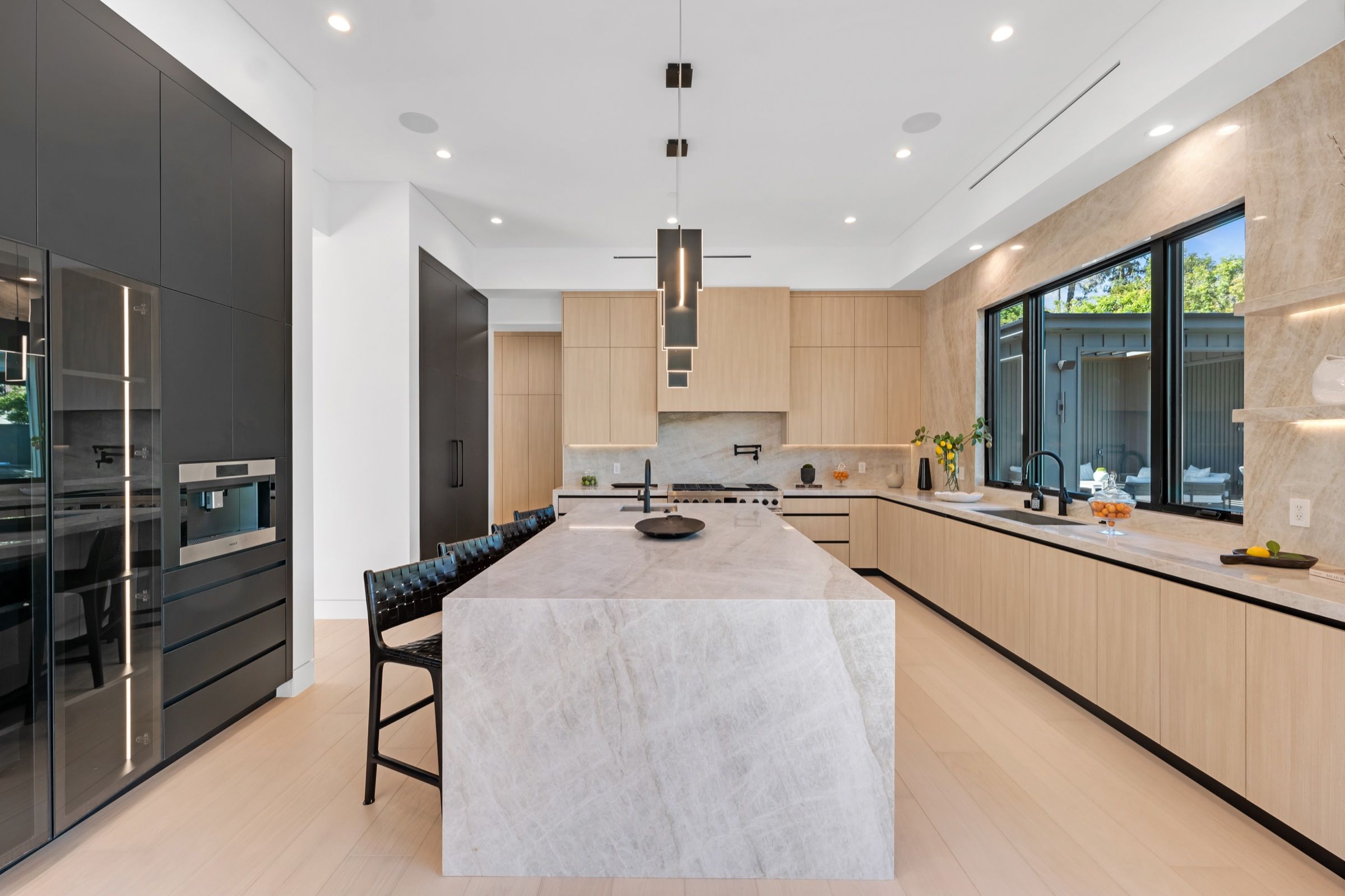 The kitchen with a quartzite island and oak cabinetry