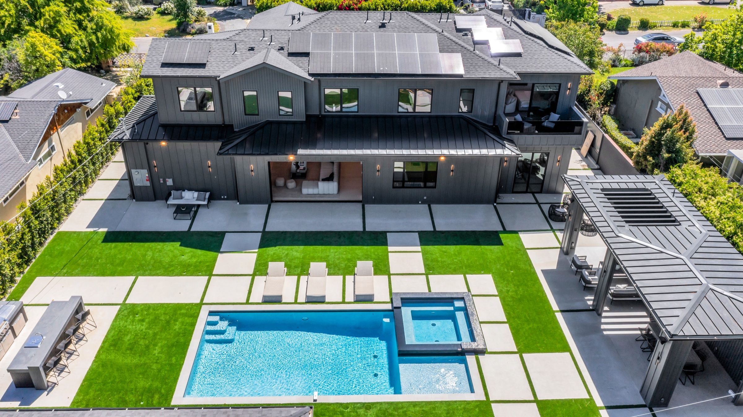 The house, pool and garden from above in daylight