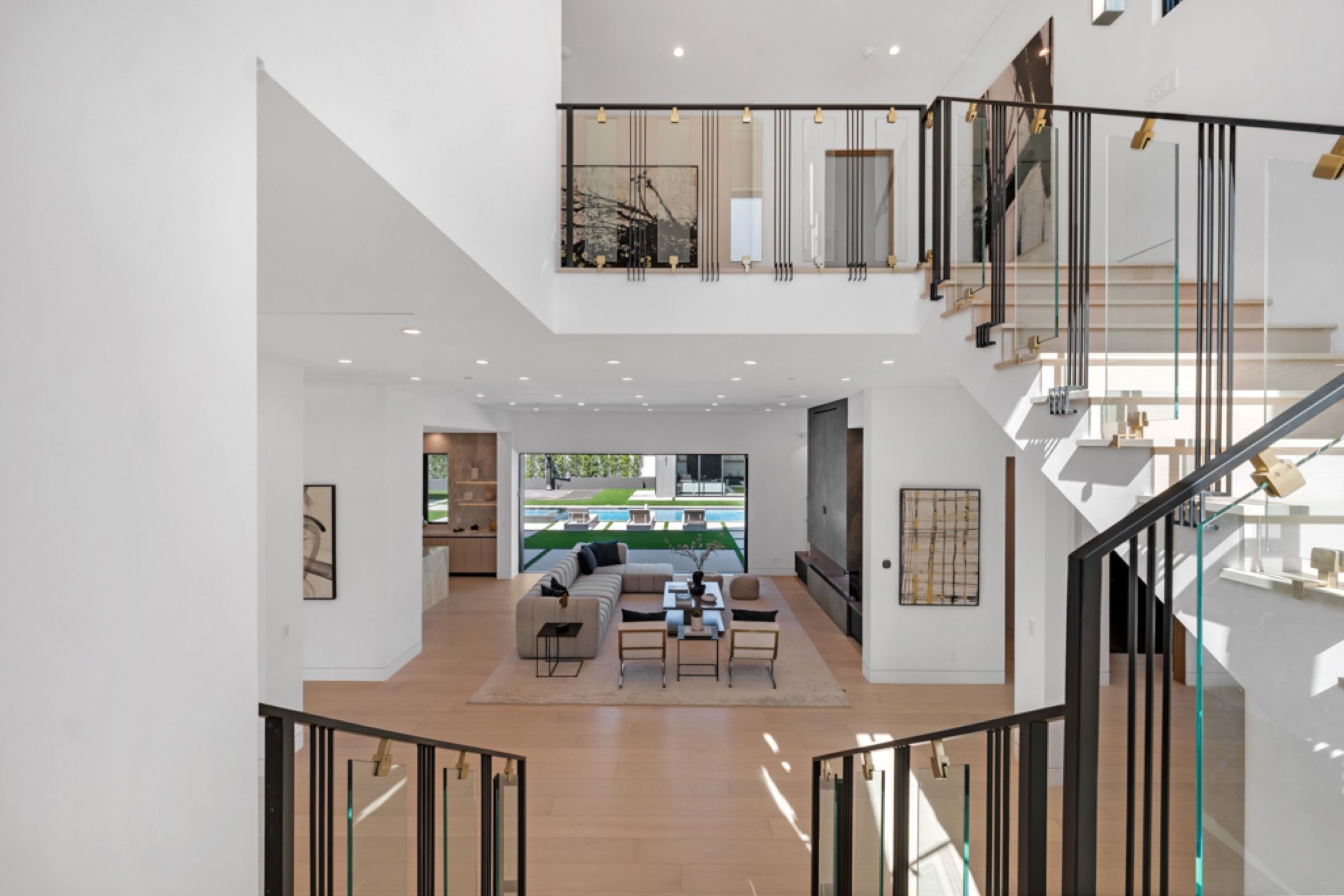 The double-height stair hall with a sculptural chandelier