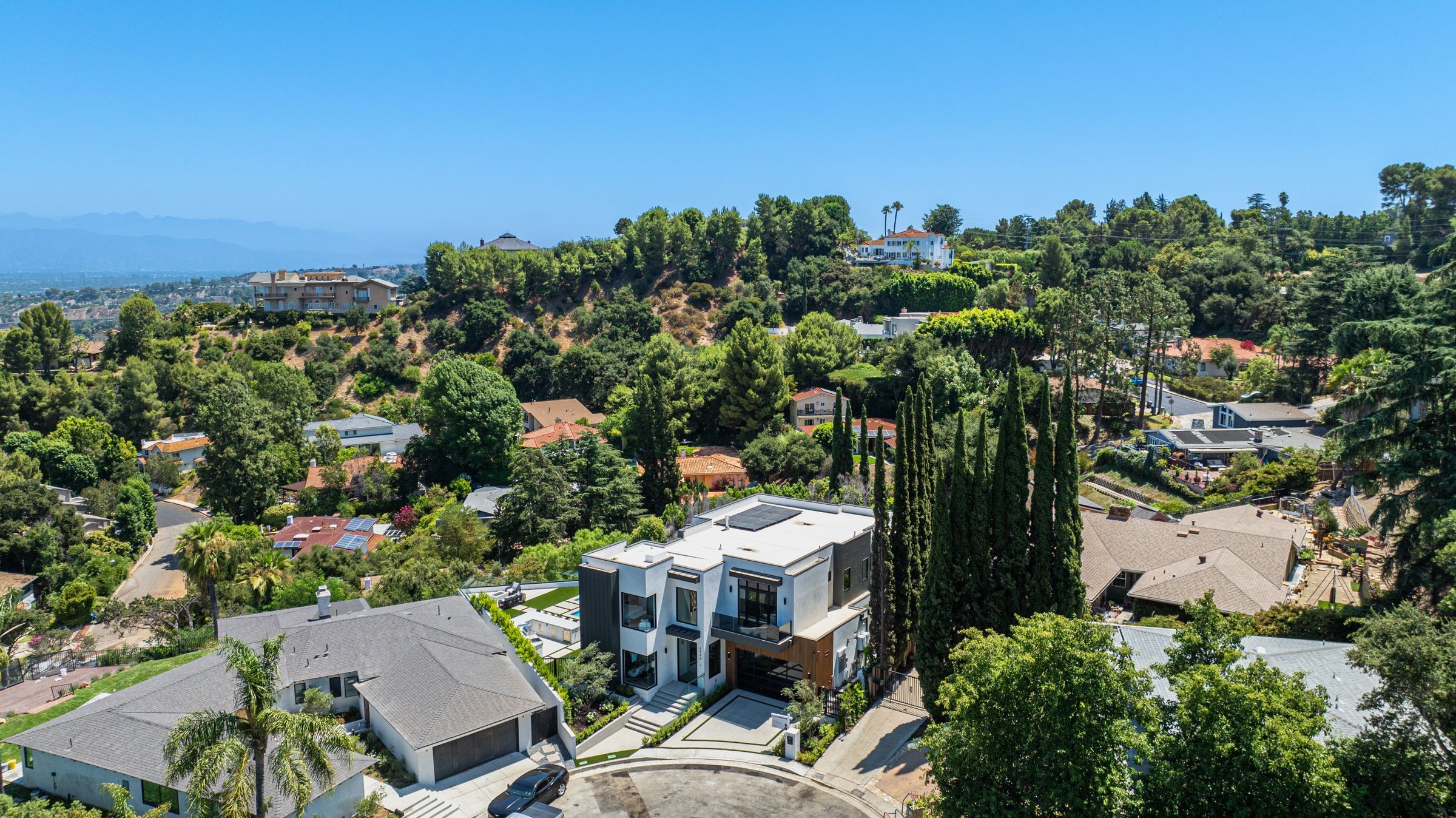 Hillside homes among trees, from above